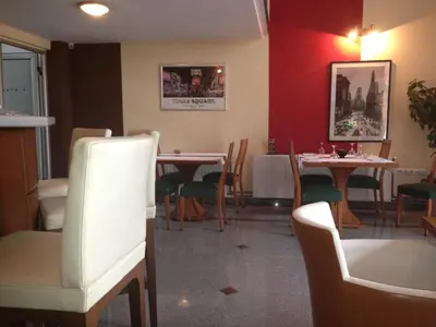 a restaurant with tables and chairs in a room at B&B Stadion in Belgrade