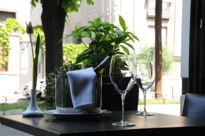 a table with two glasses of wine on a table at B&B Stadion in Belgrade