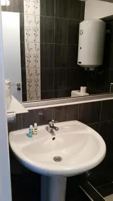 a bathroom with a white sink and a mirror at B&B Stadion in Belgrade