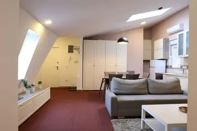 a living room with a couch and a kitchen at Belgrade Center Apartment Nusiceva in Belgrade