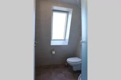 a bathroom with a toilet and a window at Belgrade Center Apartment Nusiceva in Belgrade