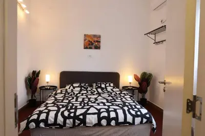 a bedroom with a black and white bed and two lamps at Belgrade Center Apartment Nusiceva in Belgrade