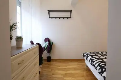 a bedroom with a bed and a dresser and a window at Belgrade Center Apartment Nusiceva in Belgrade