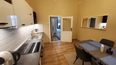 a kitchen and dining room with a table and a sink at Yes Apartment, Belgrade Center in Belgrade