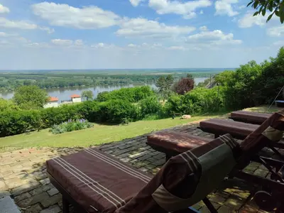 a bench with a view of a river at House 33 in Stari Slankamen