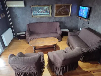a living room with two chairs and a table at House 33 in Stari Slankamen