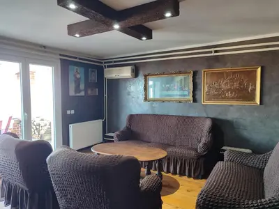 a living room with two chairs and a table at House 33 in Stari Slankamen