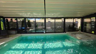 a large swimming pool with a large group of windows at Vila MP Banstol 4*- Brdež do, Fruška gora in Inđija
