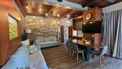a kitchen and living room with a table and a tv at Vila MP Banstol 4*- Brdež do, Fruška gora in Inđija