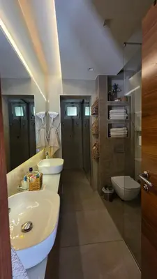 a bathroom with two sinks and a shower and a toilet at Vila MP Banstol 4*- Brdež do, Fruška gora in Inđija