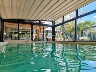 an infinity pool in a house with windows at Vila MP Banstol 4*- Brdež do, Fruška gora in Inđija