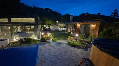 a backyard with a swimming pool at night at Vila MP Banstol 4*- Brdež do, Fruška gora in Inđija