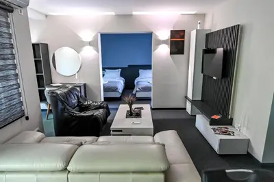 a living room with a couch and a bedroom at Respect034 in Arandjelovac
