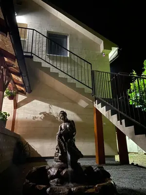 a statue of a woman in front of a staircase at OMIS Rooms in Pančevo