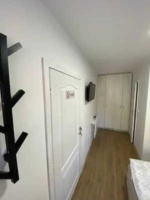 a room with a white door and a bedroom at OMIS Rooms in Pančevo