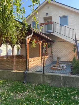 a chain link fence in front of a house at OMIS Rooms in Pančevo