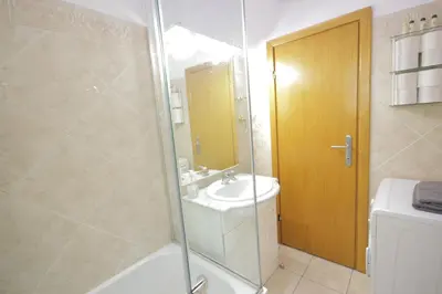 a bathroom with a shower and a sink and a toilet at Apartman Obilic in Belgrade