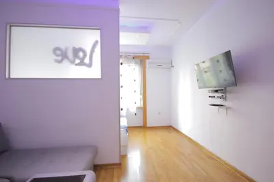 a living room with a couch and a flat screen tv at Apartman Obilic in Belgrade