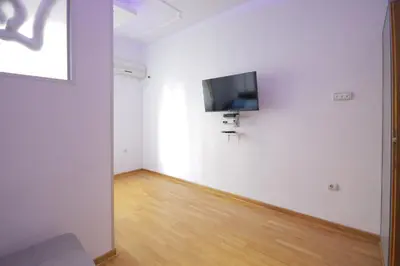 a white room with a flat screen tv on a wall at Apartman Obilic in Belgrade