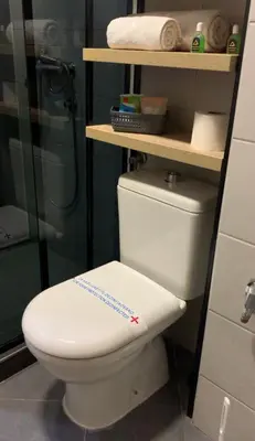a bathroom with a white toilet and a shower at Apartman Ambasador in Pančevo