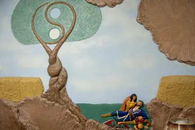 a painting of a man and a woman sitting next to a serpent at Top Spot apartment in Belgrade