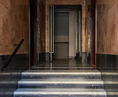 a hallway of a building with stairs and a cross at Top Spot apartment in Belgrade
