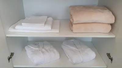 a closet with two shelves with towels and towels at Beograd na vodi - Belgrade Waterfront Riverside in Belgrade