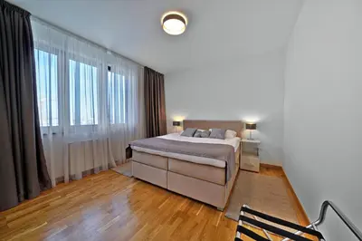 a bedroom with a bed and a large window at Beograd na vodi - Belgrade Waterfront Riverside in Belgrade