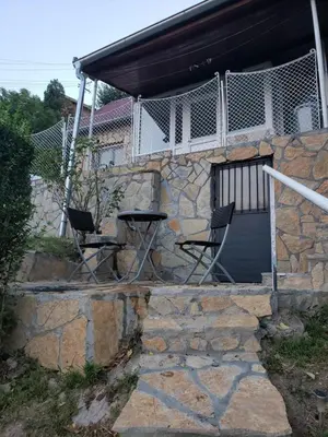 two chairs sitting on the front porch of a house at Vila Slankamenka in Stari Slankamen