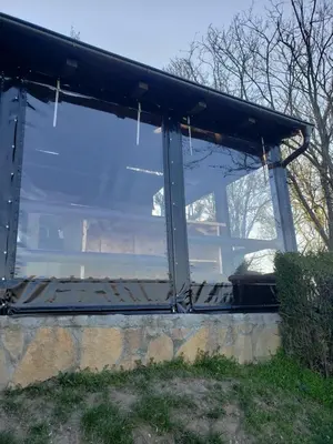 a large glass window on top of a stone wall at Vila Slankamenka in Stari Slankamen