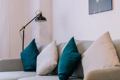 a couch with pillows and a lamp on it at Marshal Doctor in Belgrade