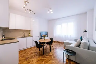a kitchen and living room with a couch and a table at Marshal Doctor in Belgrade