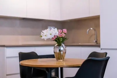 a vase of flowers sitting on a table in a kitchen at Marshal Doctor in Belgrade