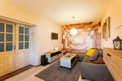 a living room with a couch and a table at Seosko Domaćinstvo Pustolov in Stari Banovci