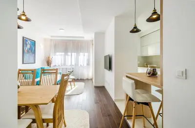 a kitchen and dining room with a table and chairs at A blok New Belgrade 2BD in Bežanija