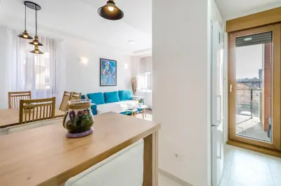 a kitchen and living room with a vase on a table at A blok New Belgrade 2BD in Bežanija