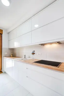 a white kitchen with white cabinets and a sink at A blok New Belgrade 2BD in Bežanija