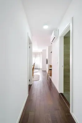 an empty hallway with white walls and wood floors at A blok New Belgrade 2BD in Bežanija