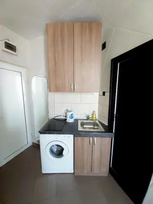 a kitchen with a sink and a washing machine at City View in Belgrade