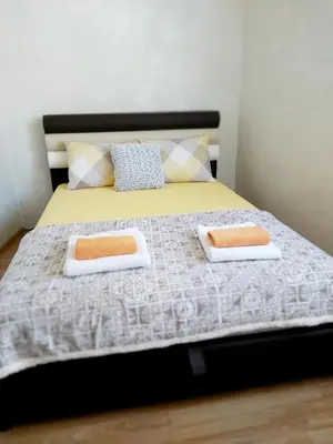 a bedroom with a bed with two pillows on it at City View in Belgrade