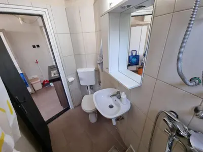 a bathroom with a sink and a toilet and a mirror at City View in Belgrade