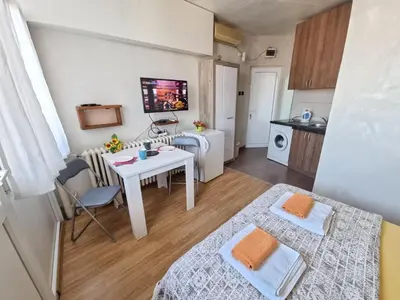 a small apartment with a table and a kitchen at City View in Belgrade