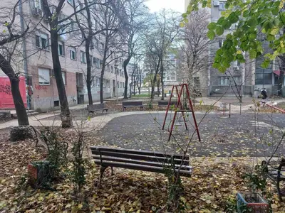 a park with a bench and a swing set at Donji Grad in Belgrade