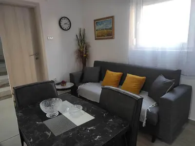 a living room with a couch and a table at Andrea Airport Apartments in Belgrade