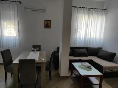 a living room with a couch and a table at Andrea Airport Apartments in Belgrade