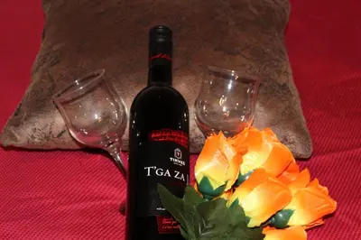a bottle of wine and two glasses on a table at Apartman EN in Dušanovac (historical)
