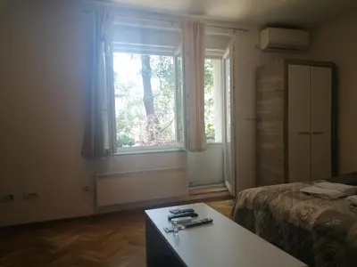 a bedroom with a bed and a window and a table at Natasa in Zvezdara