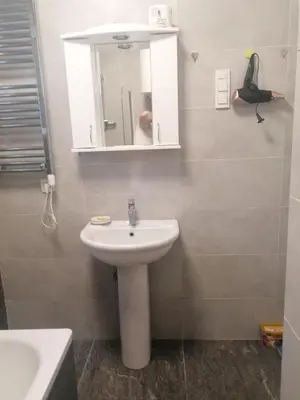 a bathroom with a white sink and a mirror at Natasa in Zvezdara