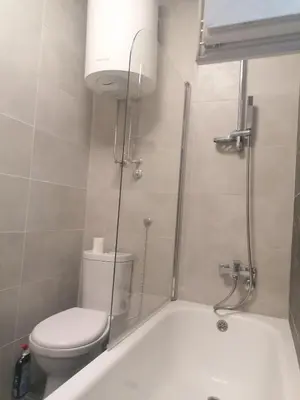 a bathroom with a toilet and a bath tub at Natasa in Zvezdara