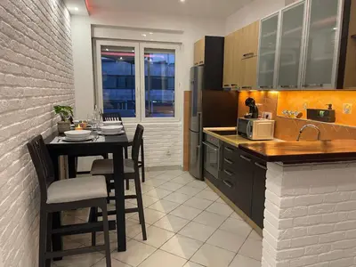 a kitchen with a table with chairs and a microwave at Allure of Belgrade (80m2-861ft2) in Belgrade